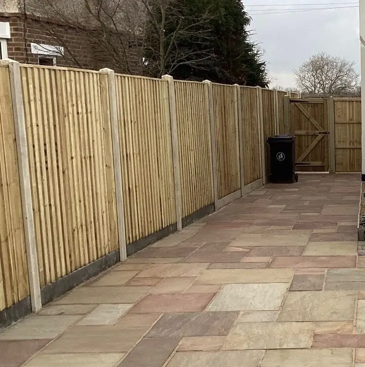New close-board fence panels and a matching gate beside a paved seating area